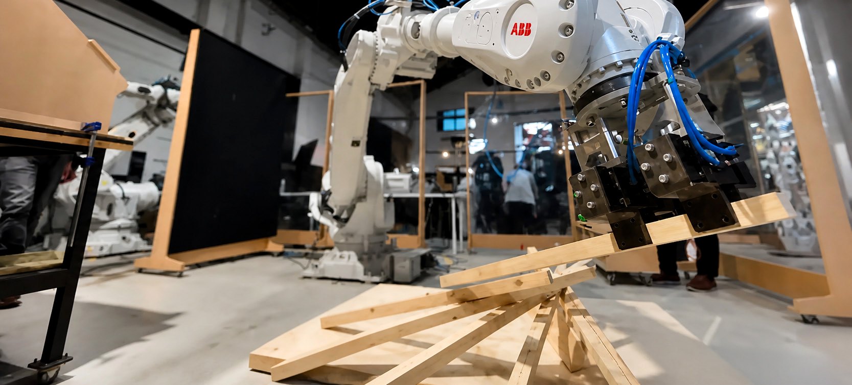 Robot placing timber sticks into an assembly.