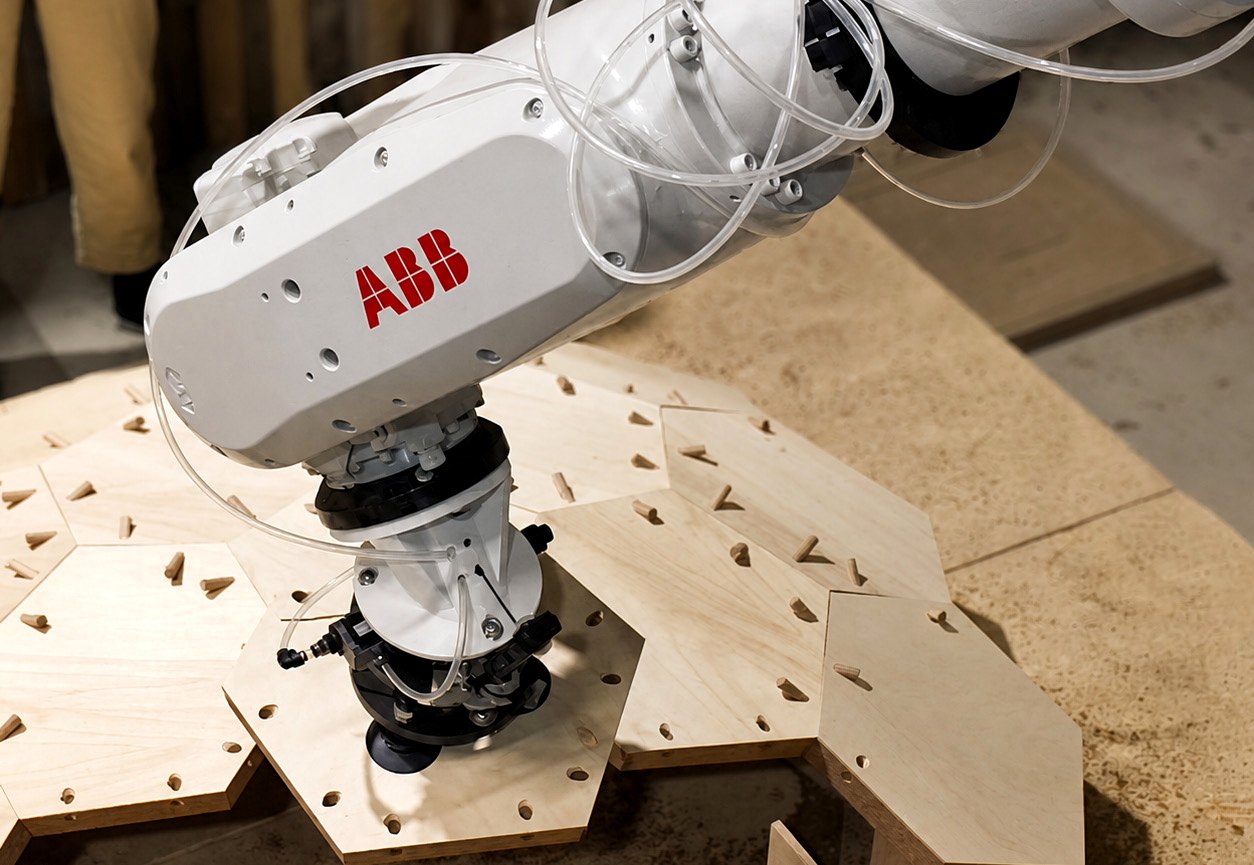 Robot setup over timber and plywood fabrication components.