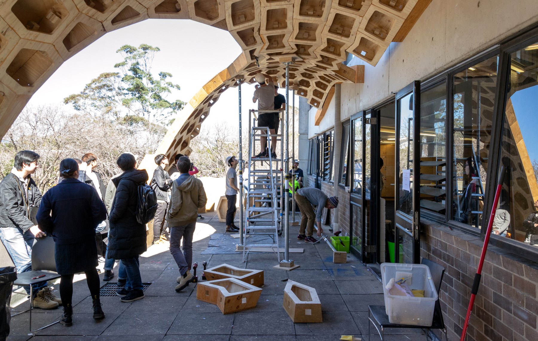 People reviewing the HexBox Canopy during on-site assembly.